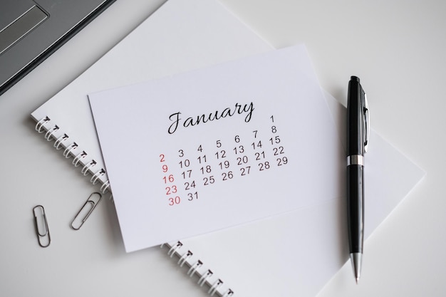 January calendar page on office desk