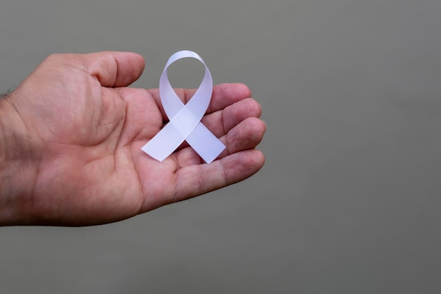 January White. hand with white ribbon. represents a mental health prevention program.