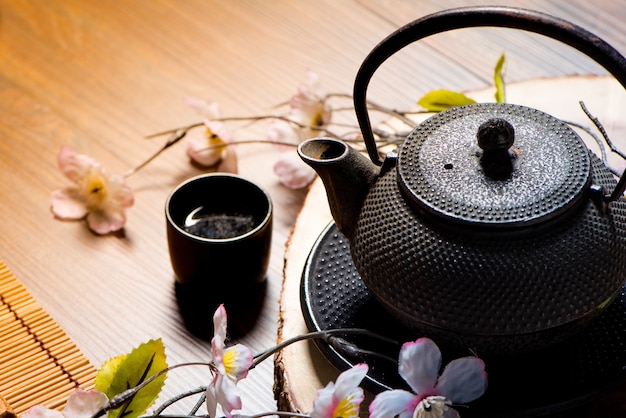 japan and chinese tea set with sakura on table wooden