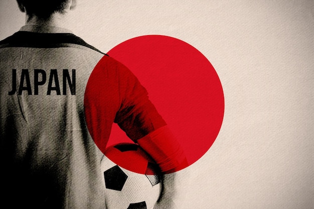 Photo japan football player holding ball against japan national flag