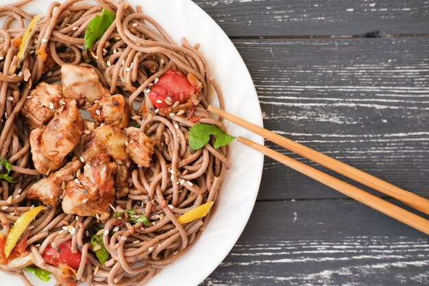 Japanese buckwheat noodle soba with vegetables chicken meat and soy sauce Healthy japanese menu selective focus asian foodtop view copy space