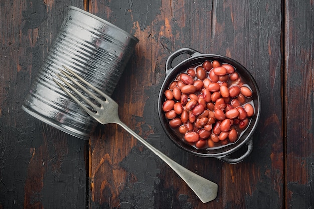 Japanese canned food ingredient, sweet red beans, on old dark  wooden table background, top view flat lay