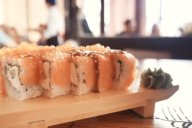 Japanese cuisine / Philadelphia rolls with salmon, and table setting in a traditional restaurant