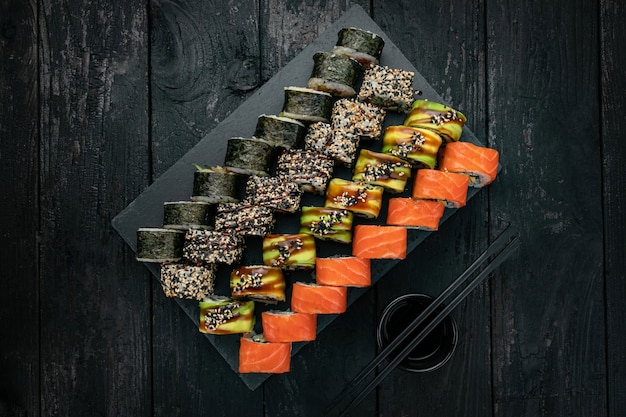 Japanese cuisine Rolls with salmon tuna on a black table