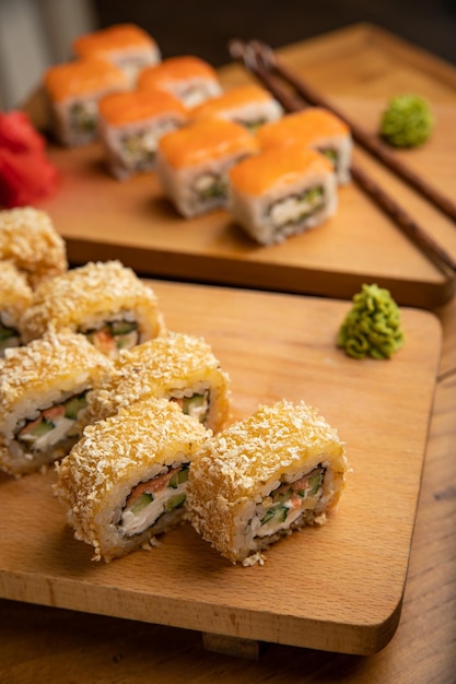 Japanese cuisine Rolls with sauce on a wooden plate