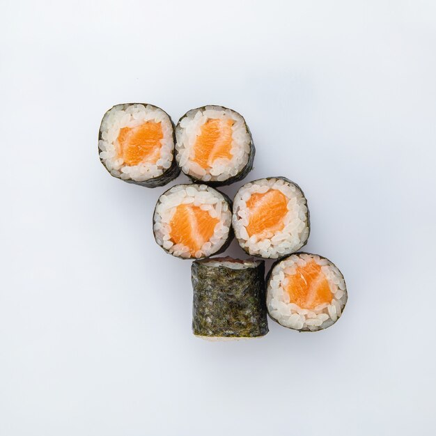 Japanese cuisine. Sushi roll with salmon on white background.