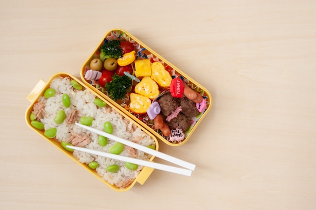 Japanese cuisine - Traditional homemade Bento box with rice, meat, egg, fish, vegetables and grains