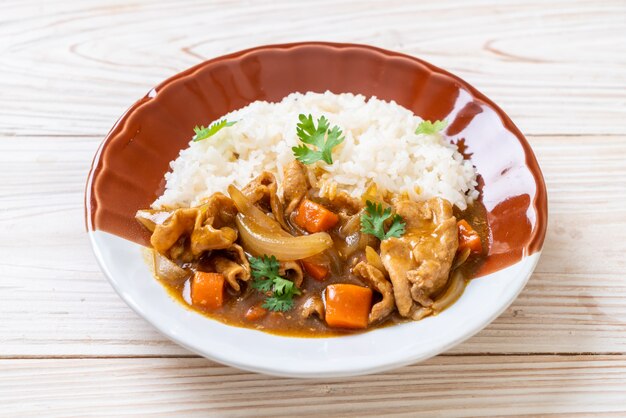 Japanese curry rice with sliced pork, carrot and onions