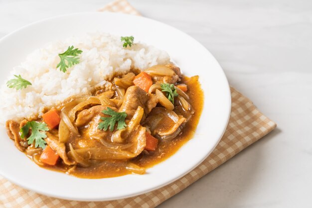 Japanese curry rice with sliced pork, carrot and onions