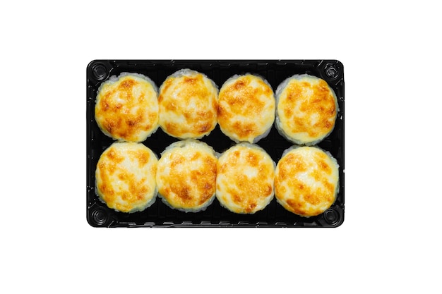 Photo japanese food, baked rolls with cheese cap in black box isolated on white background.