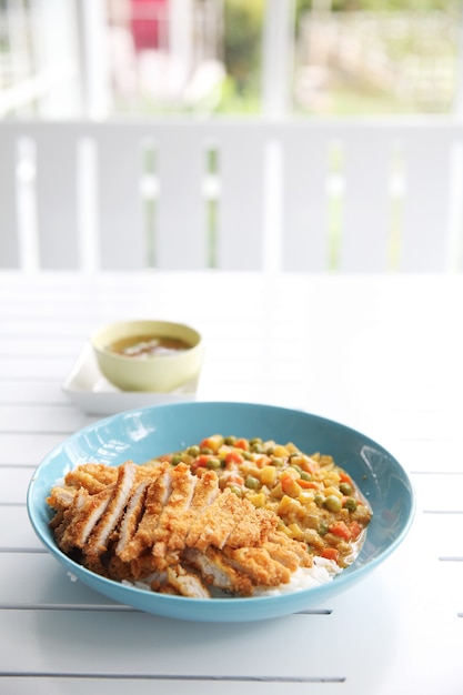 Japanese food Curry rice with fried pork on wood background