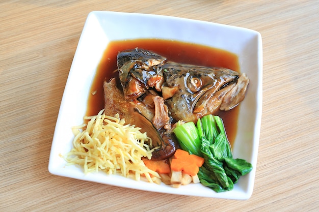 Photo japanese food, salmon kabutoni on wooden table.