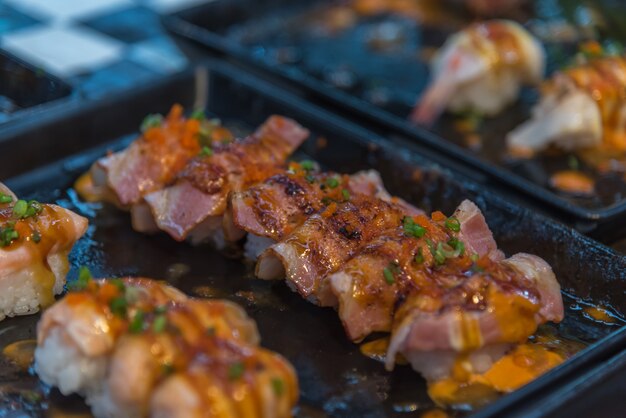 Foto cibo giapponese in set diversi tipi di sushi con insalata di alghe e gari (zenzero)