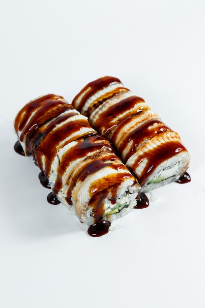 Japanese food sushi rolls with eel and cream cheese topped with unagi sauce