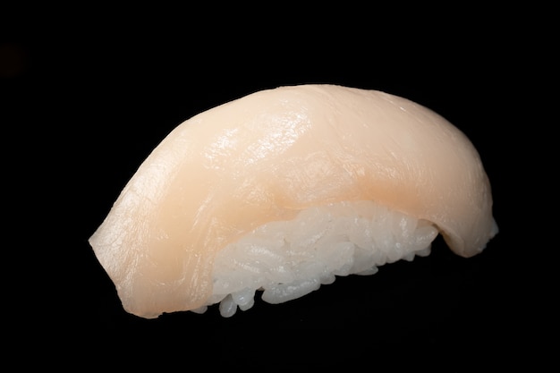 Japanese fresh sushi nigiri with scallop isolated on black