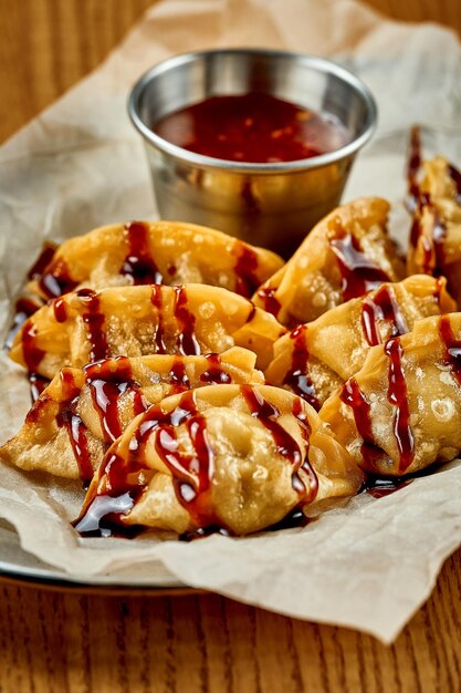 Japanese gyoza in teriyaki sauce Selective focus Closeup Noise added in postproduction