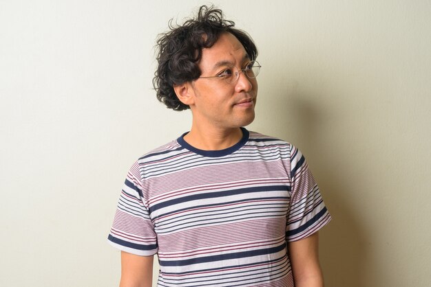 Japanese man with curly hair indoors