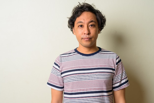 Japanese man with curly hair indoors