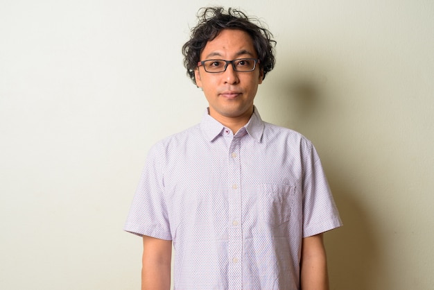 Japanese man with curly hair indoors