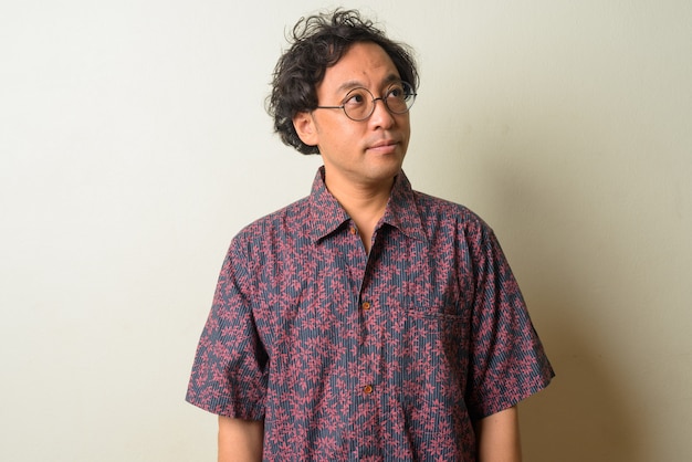 Japanese man with curly hair indoors