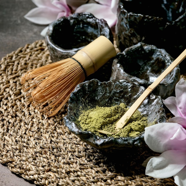 Japanese matcha green tea powder in craft ceramic bowl