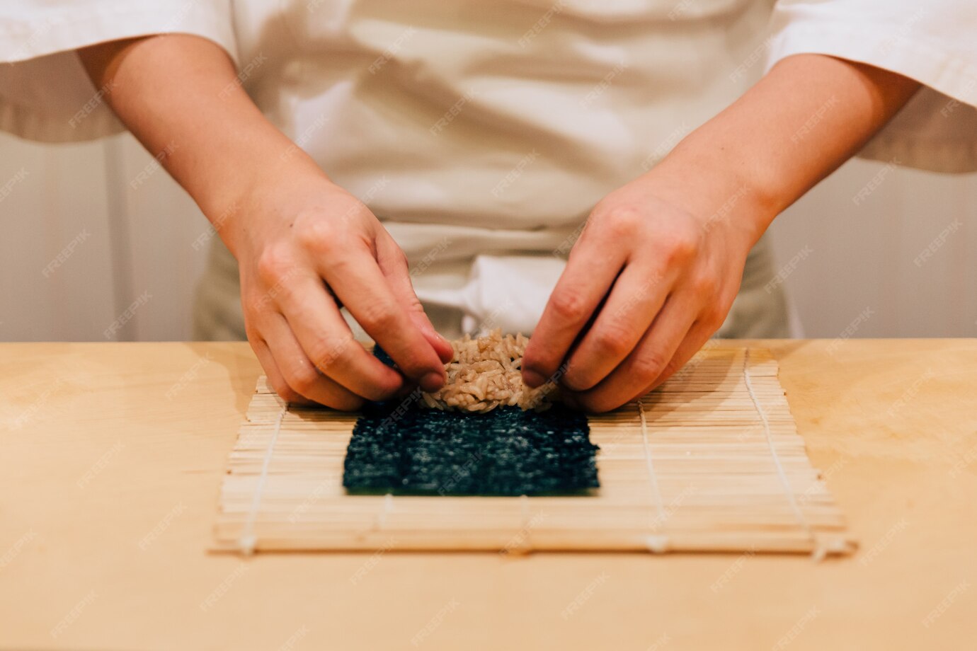 Premium Photo | Japanese omakase chef hand rolling a tuna nori handroll