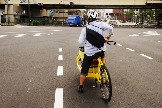 Japanese people riding new innovation bicycle waiting traffic sign for walk crosswalk traffic road junction go to work near Tokyo tower on October 21 2016 in Tokyo Japan