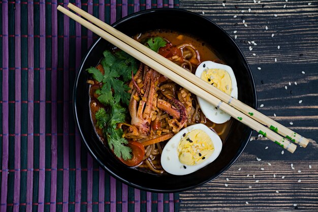 Japanese ramen with seafood, herbs and pickled eggs