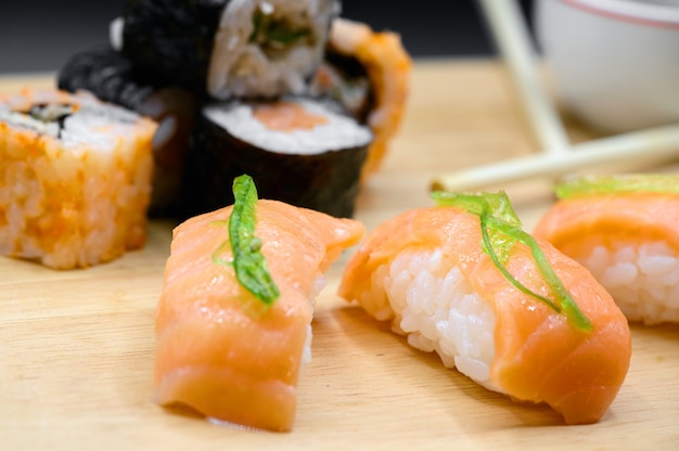 Japanese restaurant food. assorted sushi rolls on black isolated background.