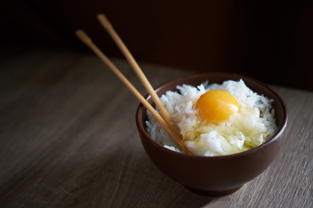 Japanese rice with raw egg in bowl