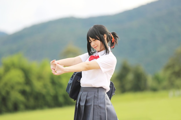 Japanese school in countryside with grass mountain and tree