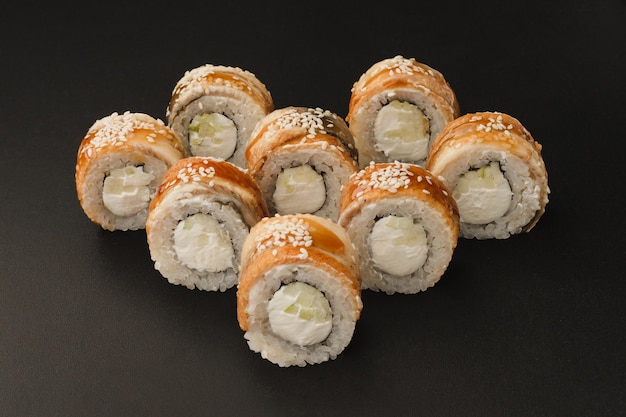 Japanese seafood sushi rolls on black background