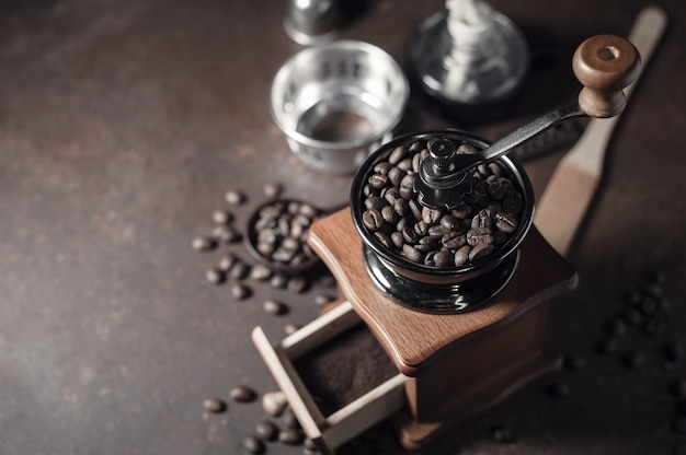 Japanese siphon coffee maker and coffee grinder on old kitchen table background.