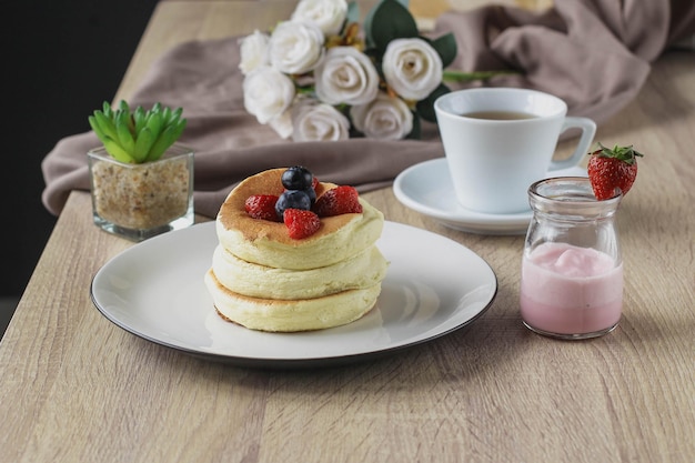 Japanese specialties called souffle pancakes served on a wooden table