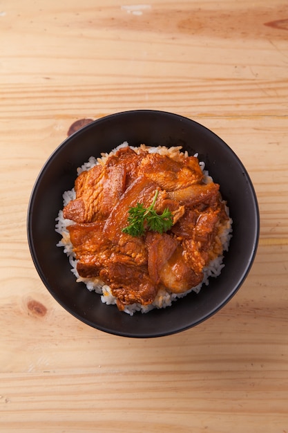 Japanese Spicy Pork Belly Rice Bowl on Wood table