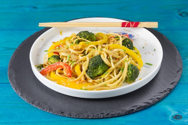 Japanese Stir fry udon noodles with vegetables on a white plate