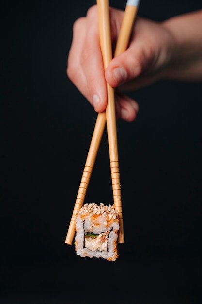 Japanese sushi caught with chopsticks.