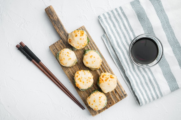 Japanese sushi rolls named Baked Ebi with wasabi and salmon fish set, on white stone