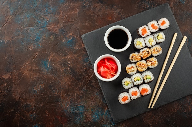 Japanese sushi on a rustic dark background.