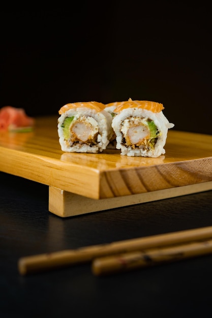 Japanese sushi sushi on a wooden board with japanese sticks