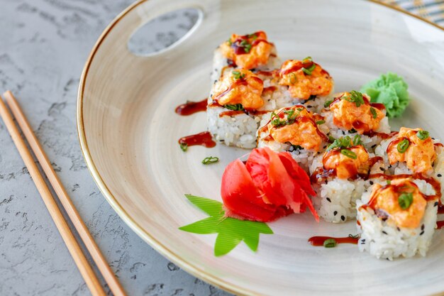 Japanese sushi with sesame seeds and cream icing on gray background