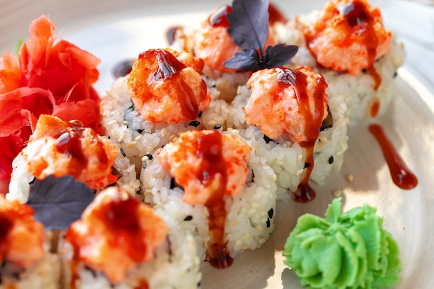 Japanese sushi with sesame seeds and cream icing on gray background