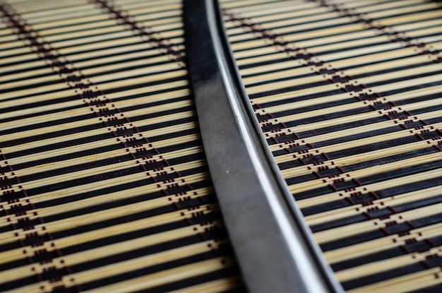 Japanese sword katana on bamboo mat