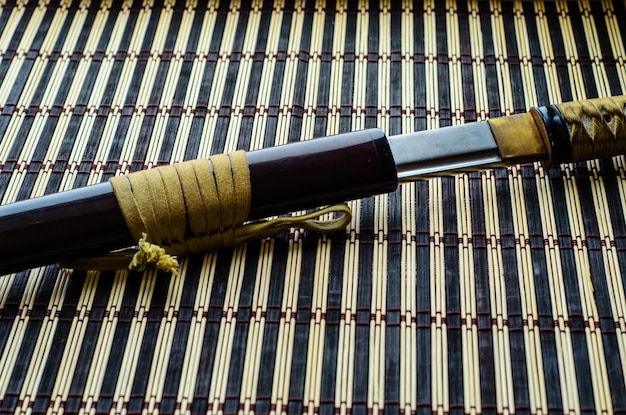 Japanese sword katana on bamboo mat