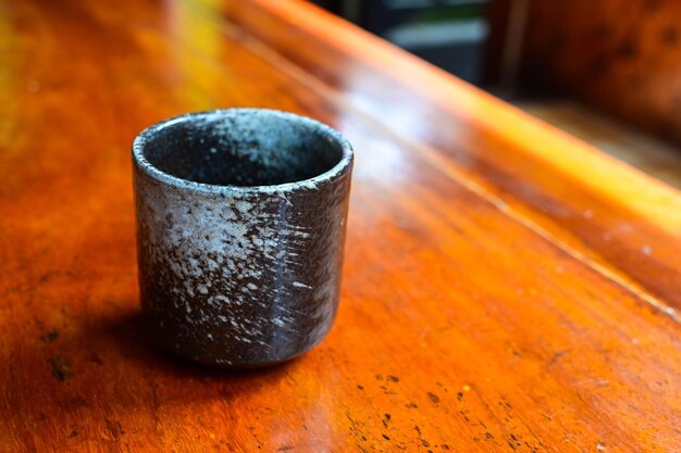 Japanese Tea cup on wooden table closeup