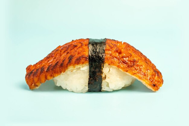 Japanese traditional cuisine Sushi nigiri with eel Unagi on blue background