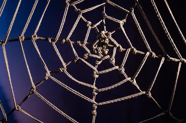 Japanese traditional technique of knitting shibari ropes in the form of a spider web no people part of the bedroom interior bdsm