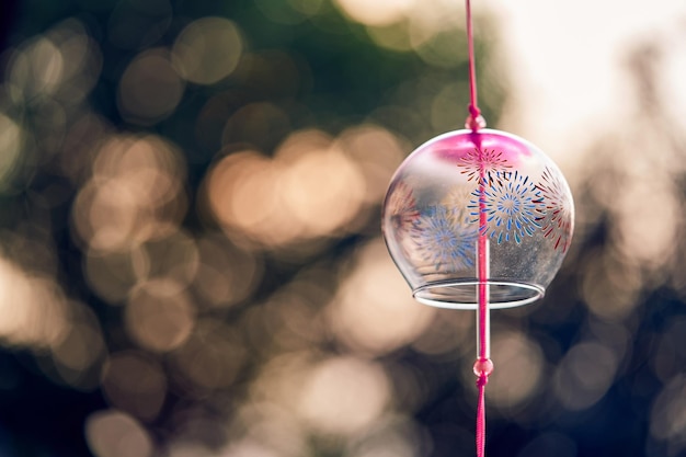 Japanese traditional wind bell or furin chimes symbol of summer on bokeh background