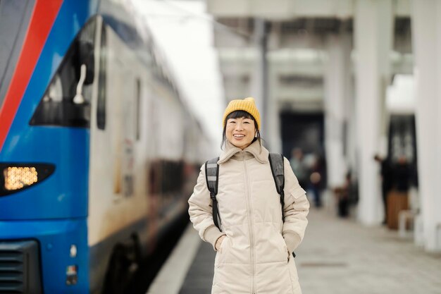 A japanese traveling woman standing at platform on train station near train