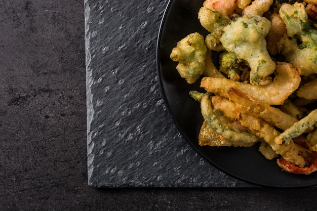 Japanese vegetable tempura on black plate